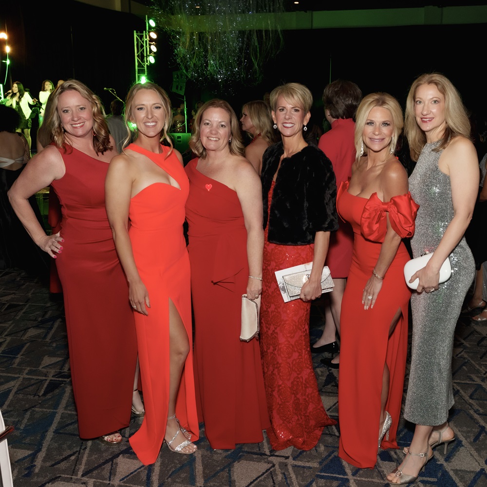 Group of six women in formal gowns.